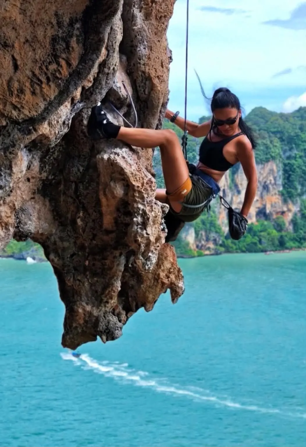 A guest climbing an overhang above the bay