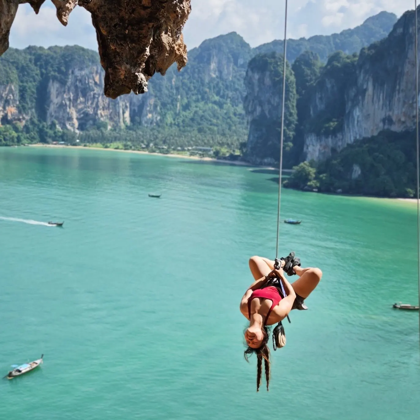 A guest hanging upside down on the rope above the bay